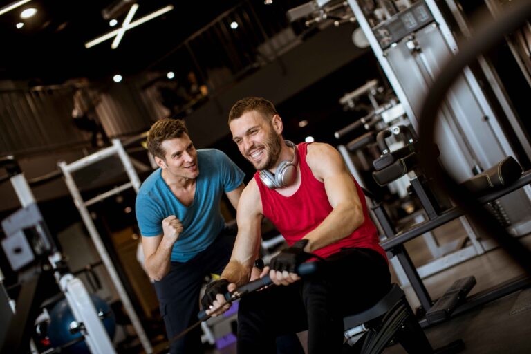 young-man-with-trainer-doing-exercise-in-the-gym-2025-02-22-12-59-31-utc_11zon Image description